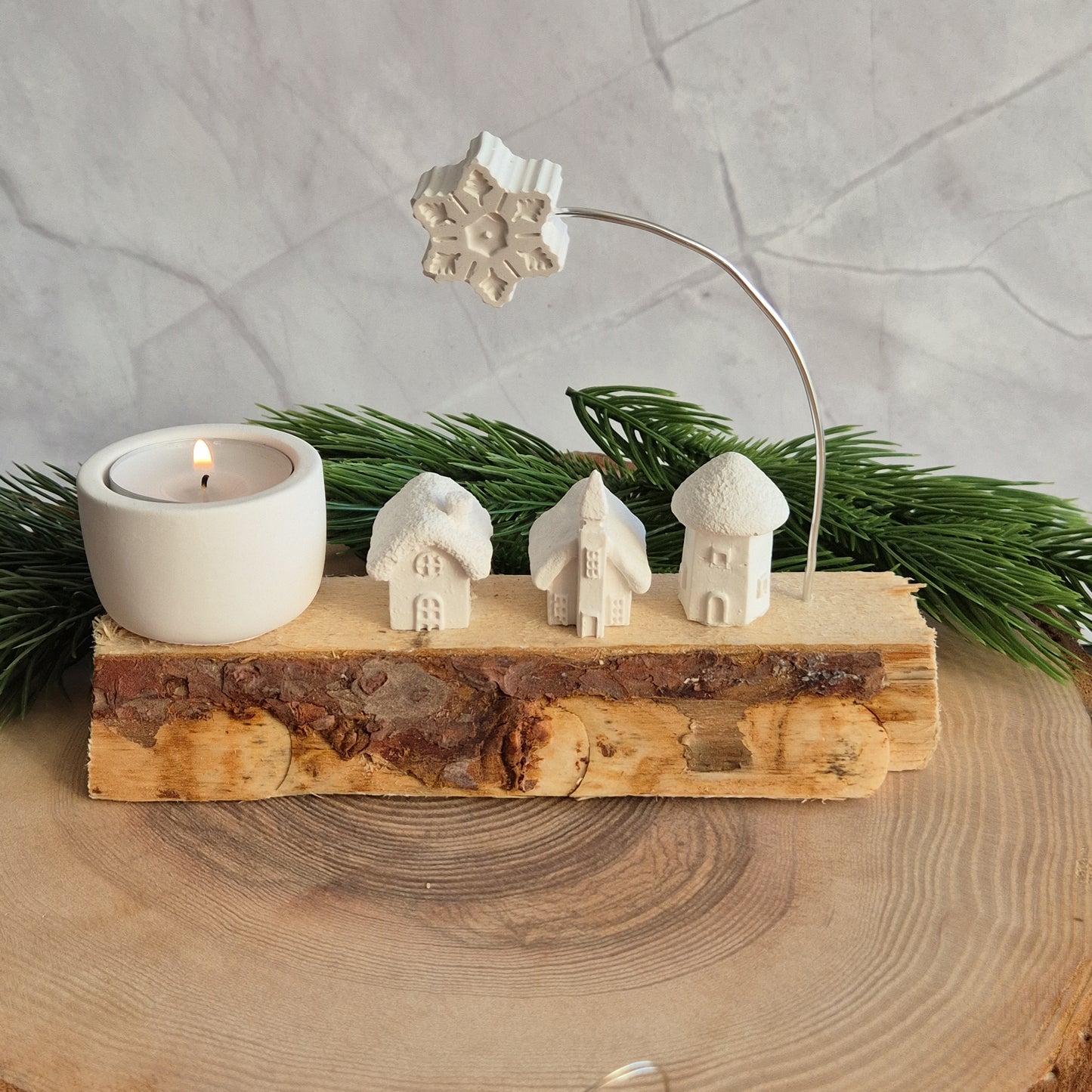 Winterliches auf Holz - verschiedene Häuschen, Bäume und Teelichthalter auf einem Holzschait